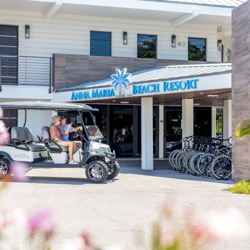 A beach resort entrance with a sign saying 